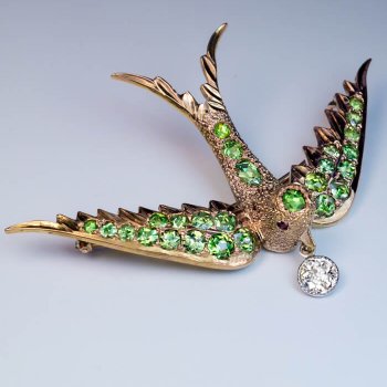 antique bird shaped brooch pin set with demantoid garnets and an old cut diamond