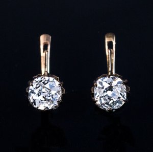 antique diamond solitaire earrings set with old cushion cut diamonds