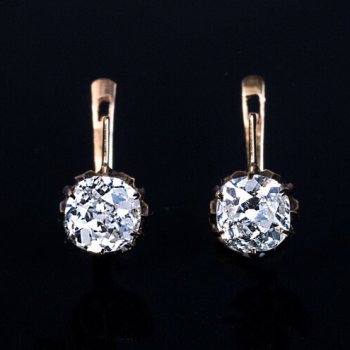 antique diamond solitaire earrings set with old cushion cut diamonds