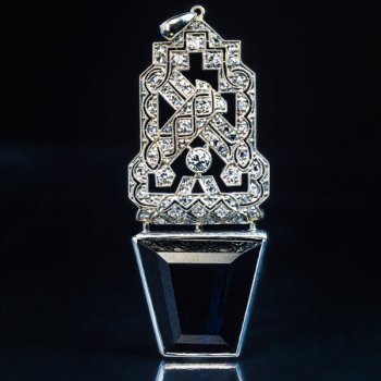 Art Deco openwork platinum diamond and tapered step cut sapphire pendant