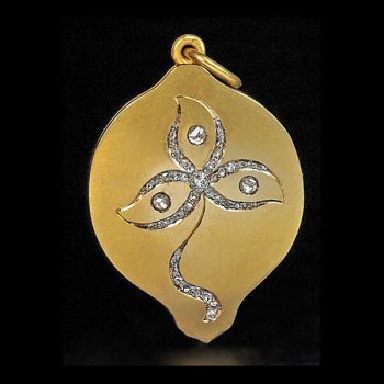 Art Nouveau gold locket pendant with a diamond flower