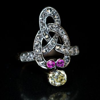 Victorian antique knot ring set with a fancy color old mine cut diamond, rose cut diamonds and rubies