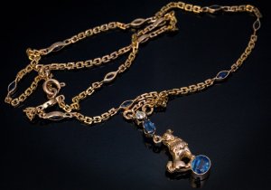antique gold necklace with a dog charm