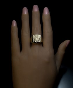 gold signet ring engraved with a coat of arms